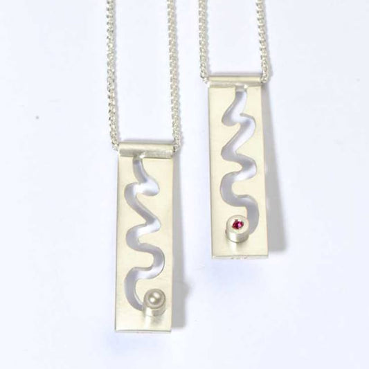 Friendship pendants with moving birthstones.