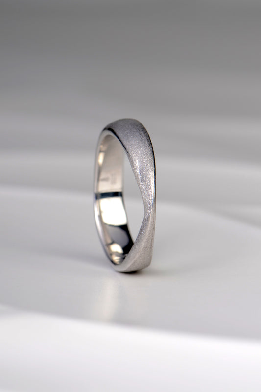 Jorge Revilla brushed silver ring from his forge collection. A modern design that is sculptural and raised to a peak at the front