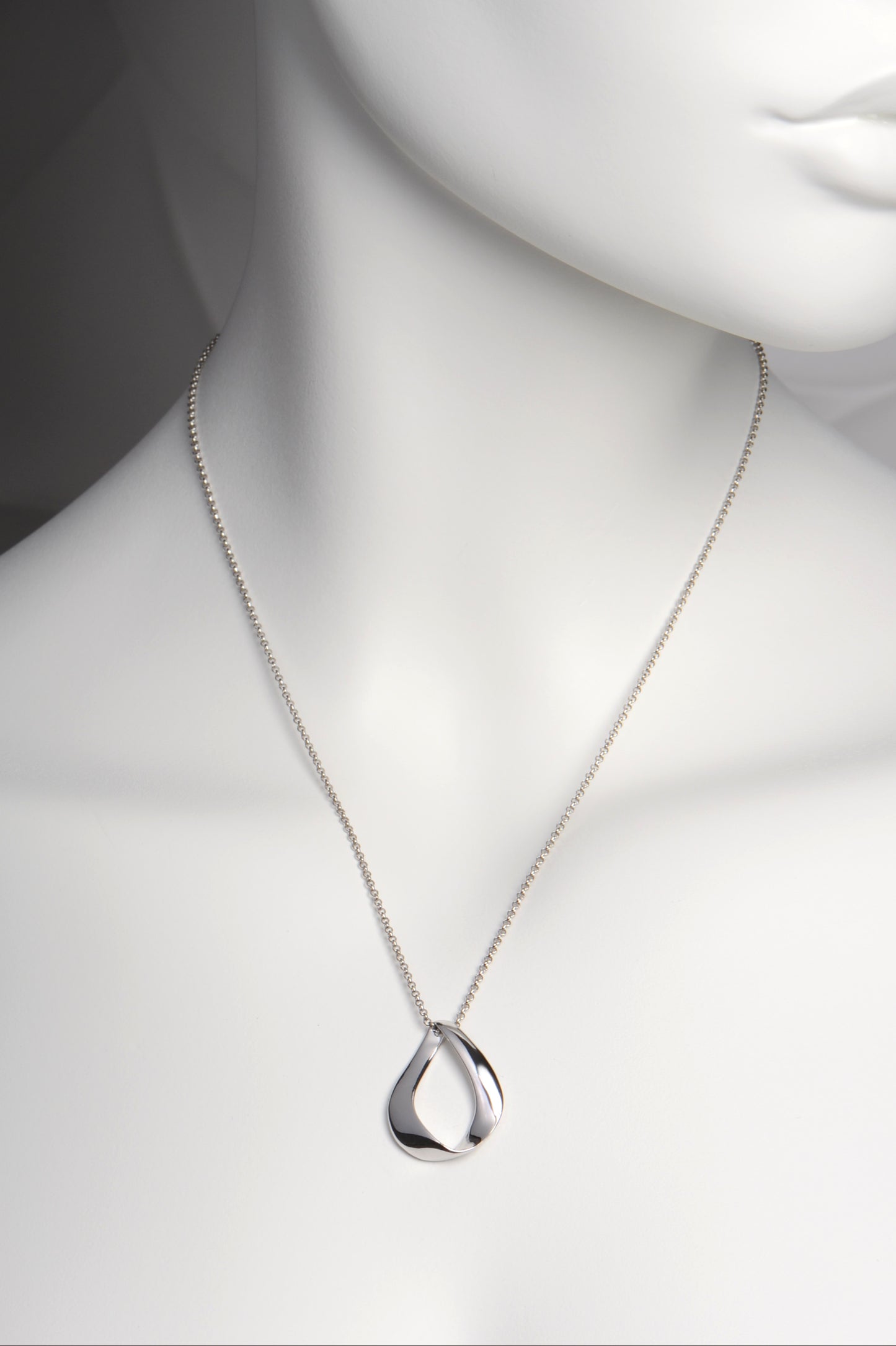 romantic sterling silver necklace by Jorge Revilla called Love Ribbon. The teardrop shape formed by a narrow ribbon of silver is a mobius strip that is a symbol for unending love.