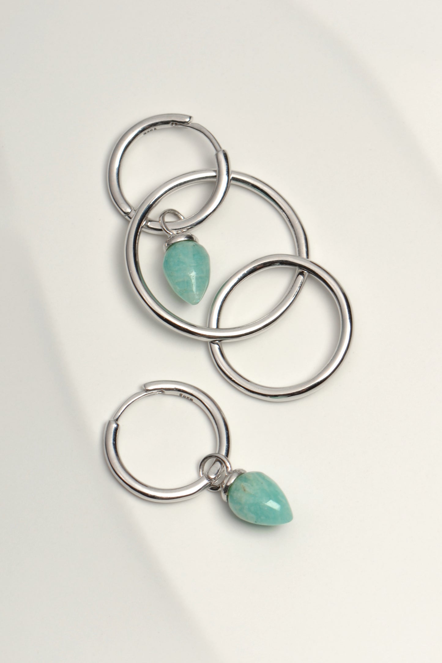 designer silver hoop long drop earrings with real gemstones that can be worn in four different ways from jewellery designer Jorge Revilla