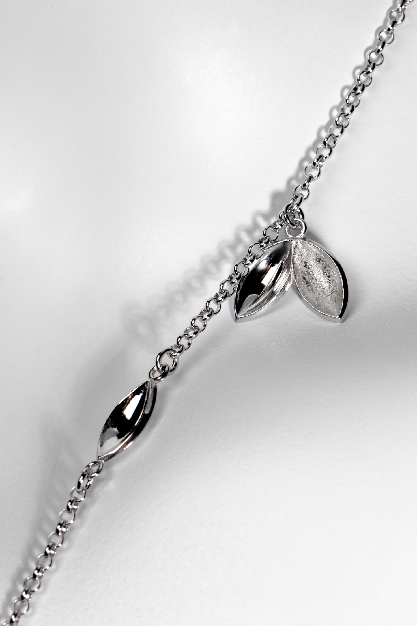 Modern seed shaped silver charm necklace. Called The Promise, for each one sold a tree is planted in Scotland