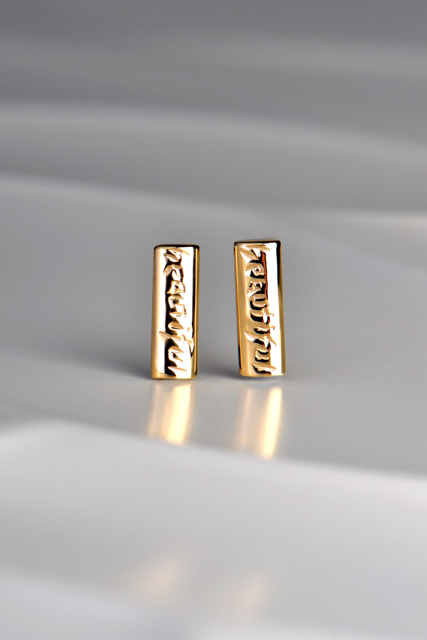 handmade small real yellow gold bar earrings engraved with the word, beautiful