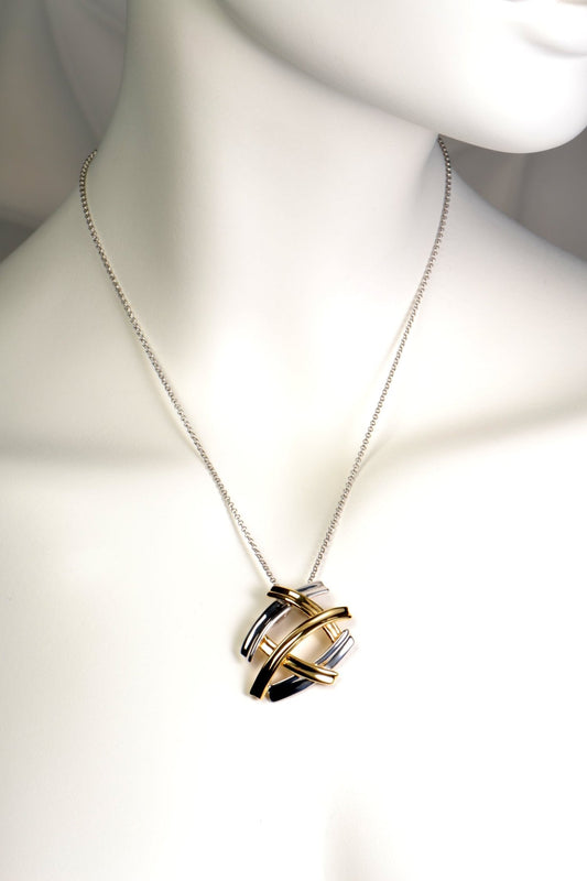 five criss cross bands create a pendant that looks like several large silver and gold kisses. The necklace in silver with gold vermeil.