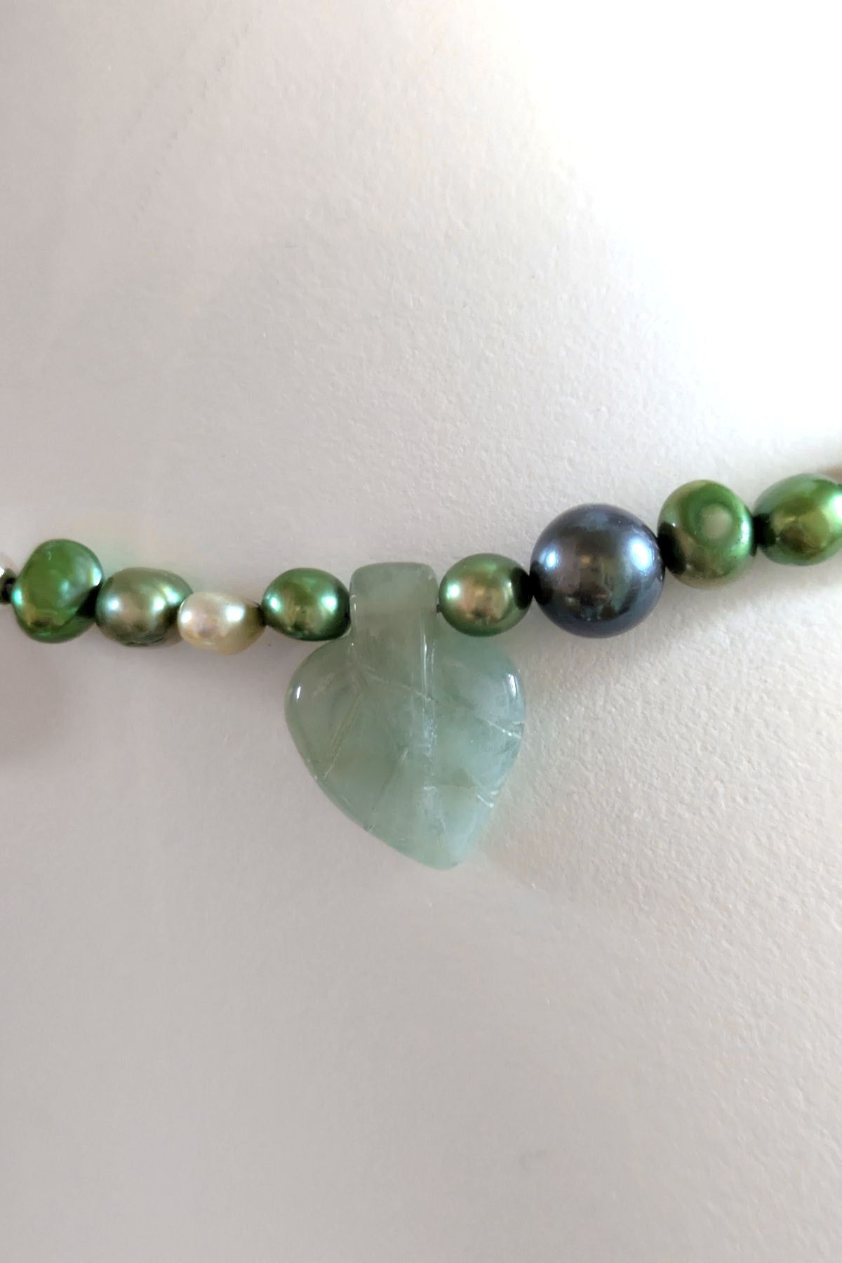 green beryl leaf detail in green and black cultured pearl necklace