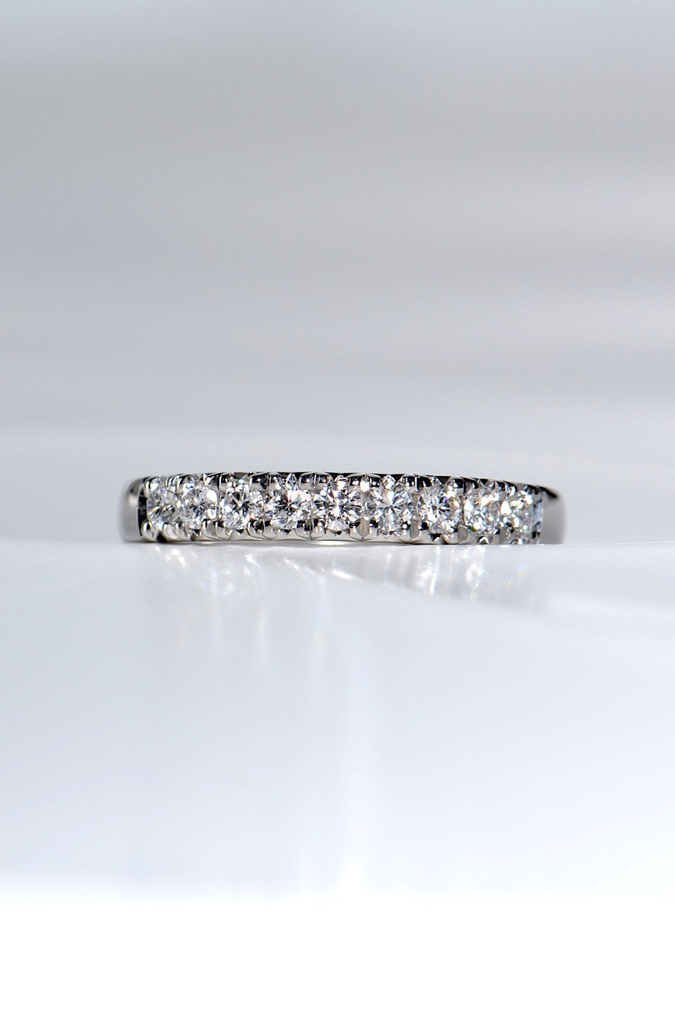 sparkling platinum band with nine round diamonds, ideal as a modern wedding or eternity ring.