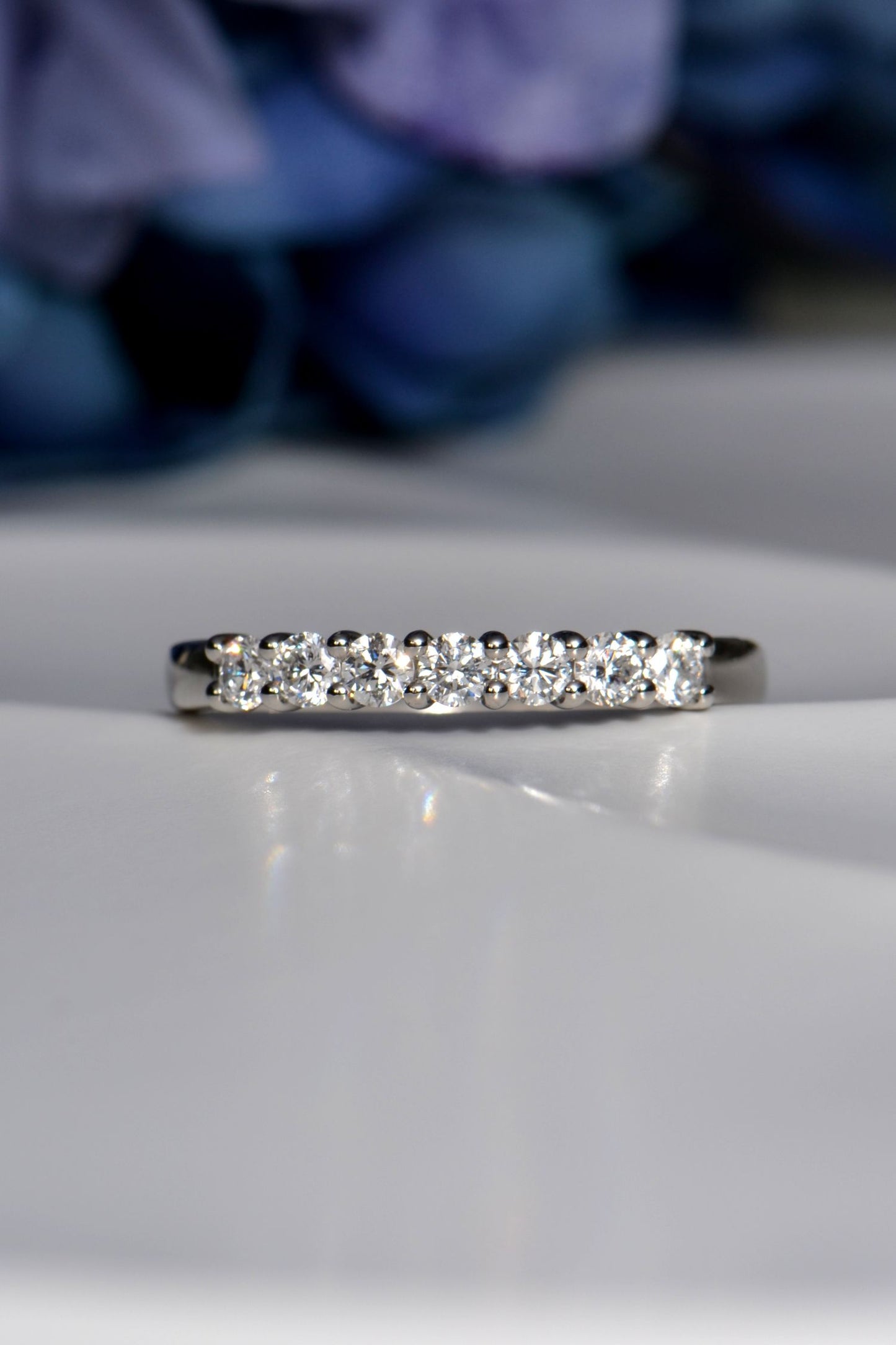 7-stone half carat ring worn as wedding or eternity ring, handmade in Britain with claw-set diamonds