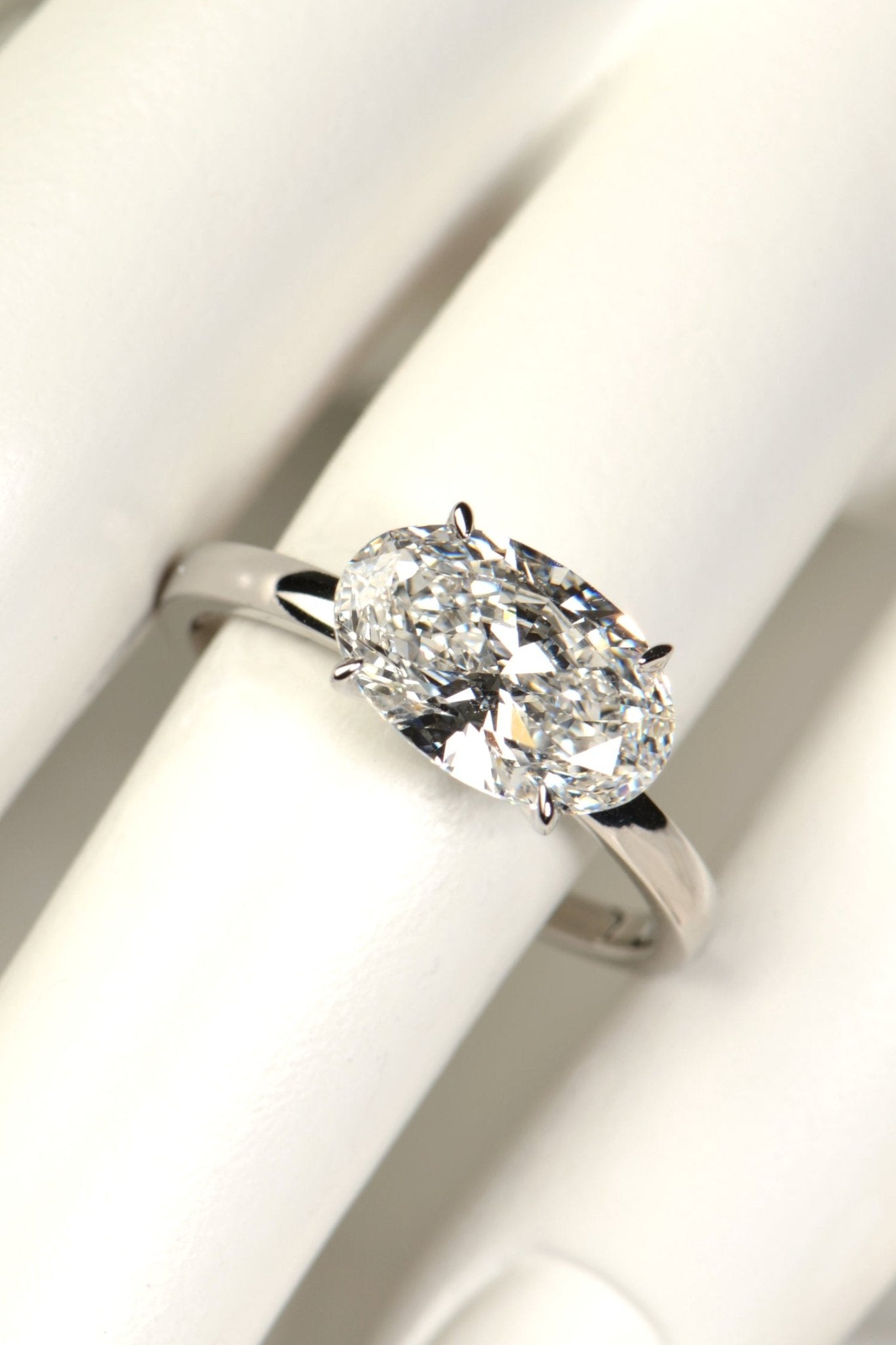 Platinum 3 carat east–west oval lab-grown diamond ring on mannequin hand, crafted in Britain with sustainable luxury design