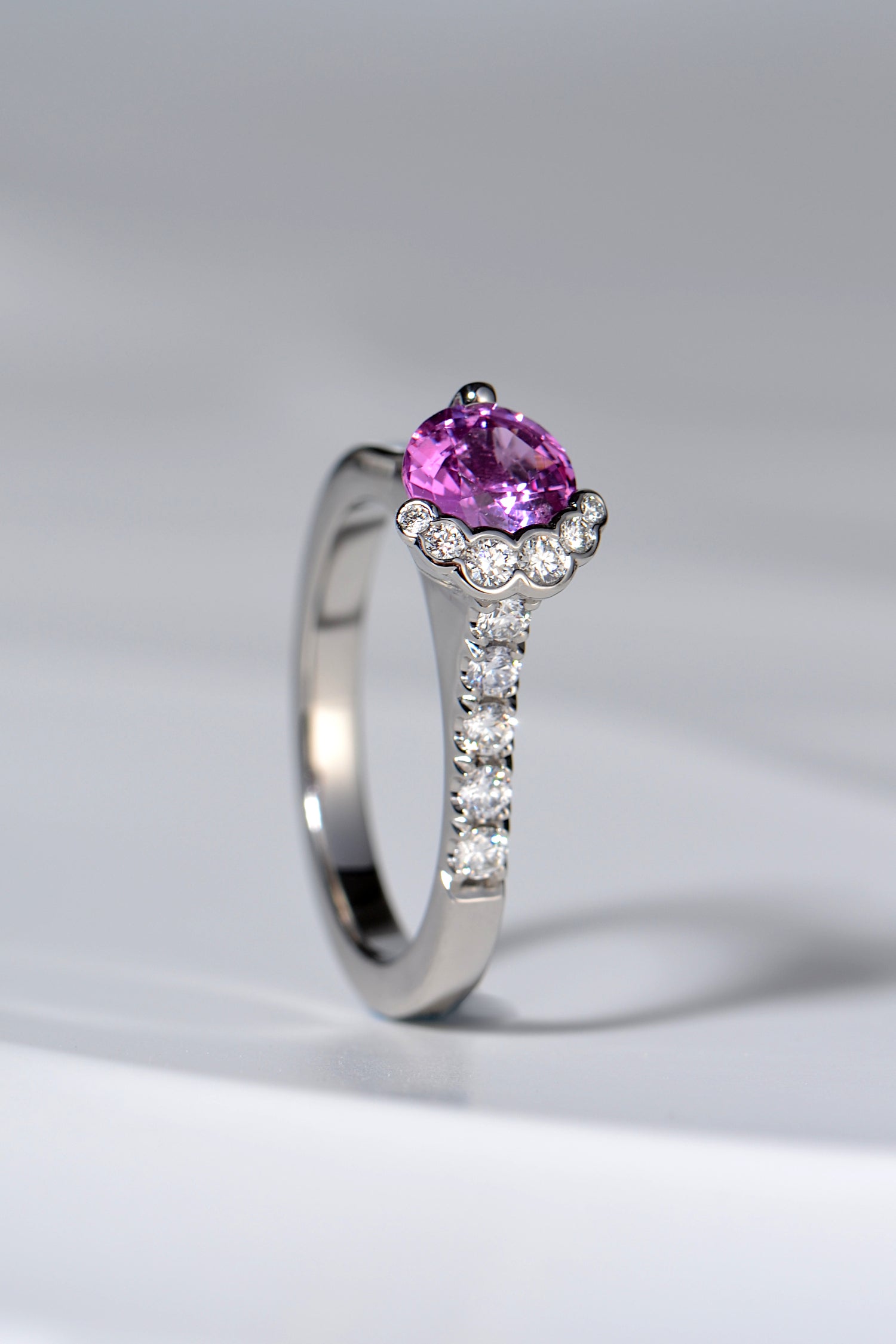 scottish designer engagement ring with a river of diamonds that flow out of a pink sapphire centre stone inspired by the Fairy Pools on the Isle of Skye