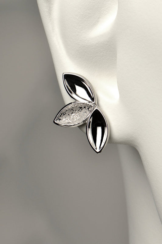 fairy like large silver stud earring made of three concave seed pod shapes in highly polished and contrasting modern textured finishes. The Promise jewellery collection from Christine Sadler plants a tree for every piece sold.