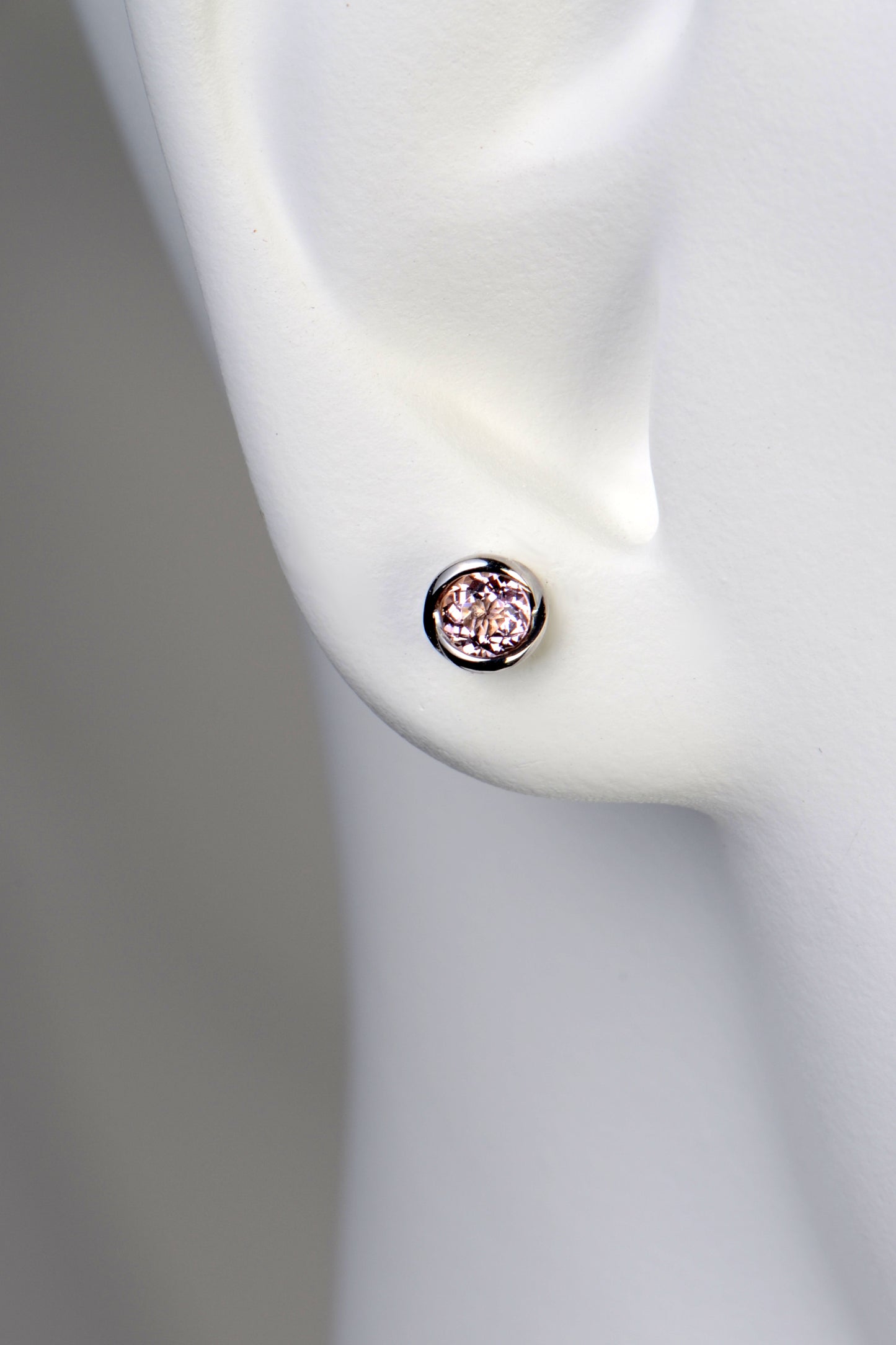 small round morganite earrings in a earlobe