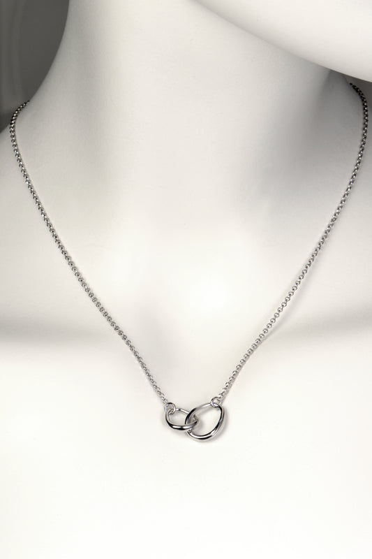 interlocking silver circle necklace with two oval egg shaped links at the front, one larger and one smaller, on a fine silver chain. Part of Christine Sadler's Soulmates collection