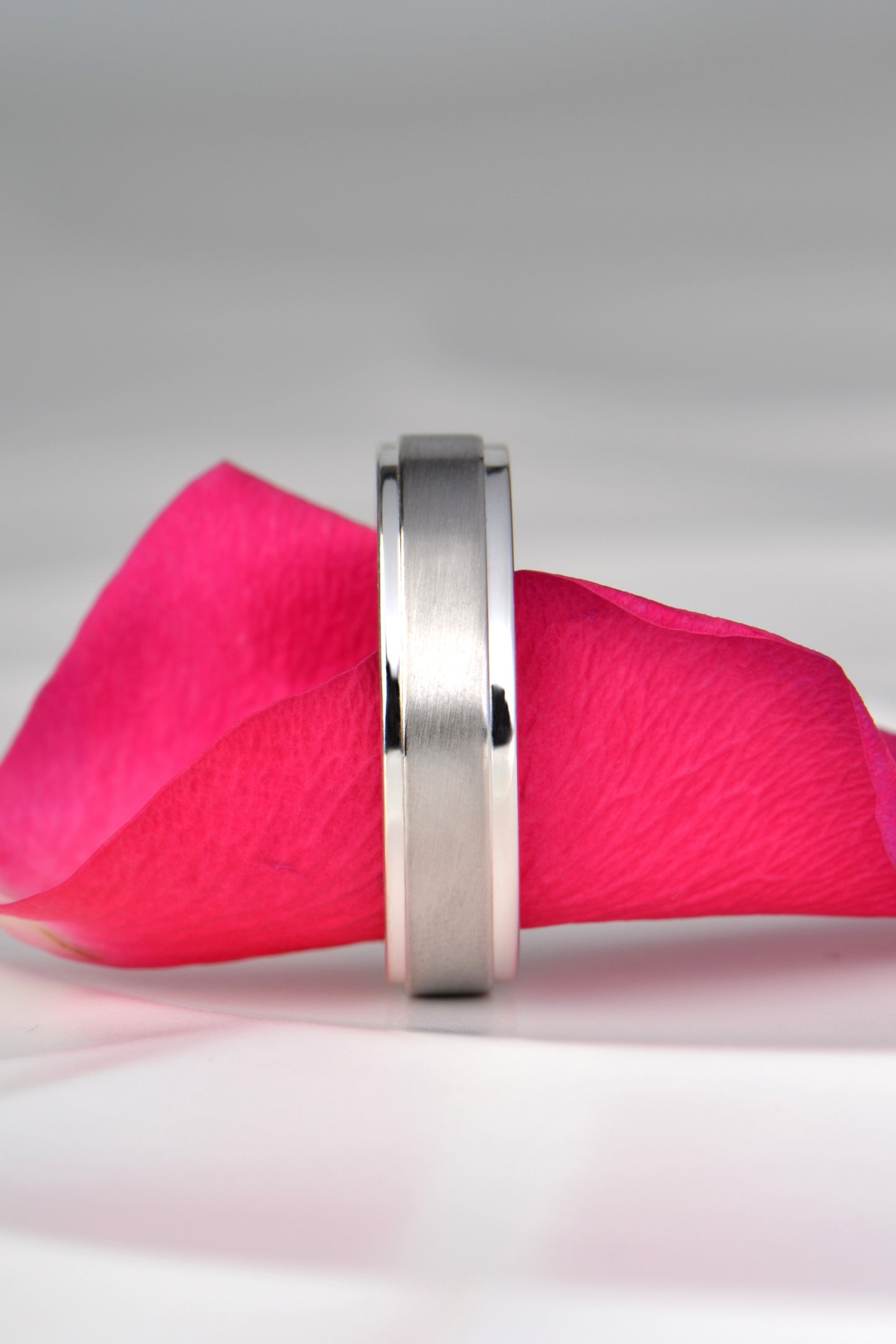 modern wedding ring for a man that is different and affordable, made in silver with a platinum sleeve on top