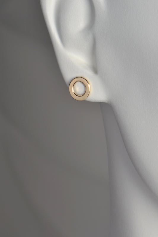 a circle of gold earrings with a space in the middle . They are 10mm in diameter and the bottom of the earring sits just below the earlobe.