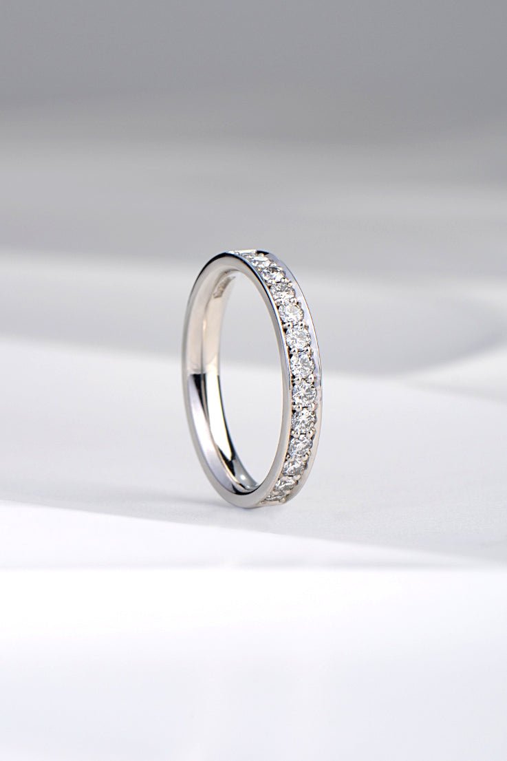 handmade diamond eternity ring or wedding ring set with diamonds half way round the band from Christine Sadler