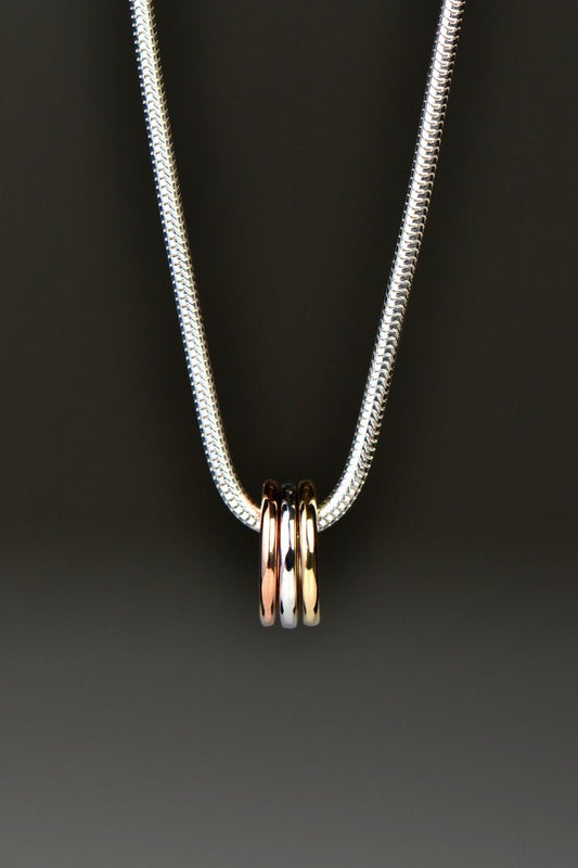 small silver, rose gold and yellow gold circles on a silver necklace from Christine Sadler Unforgettable Jewellery