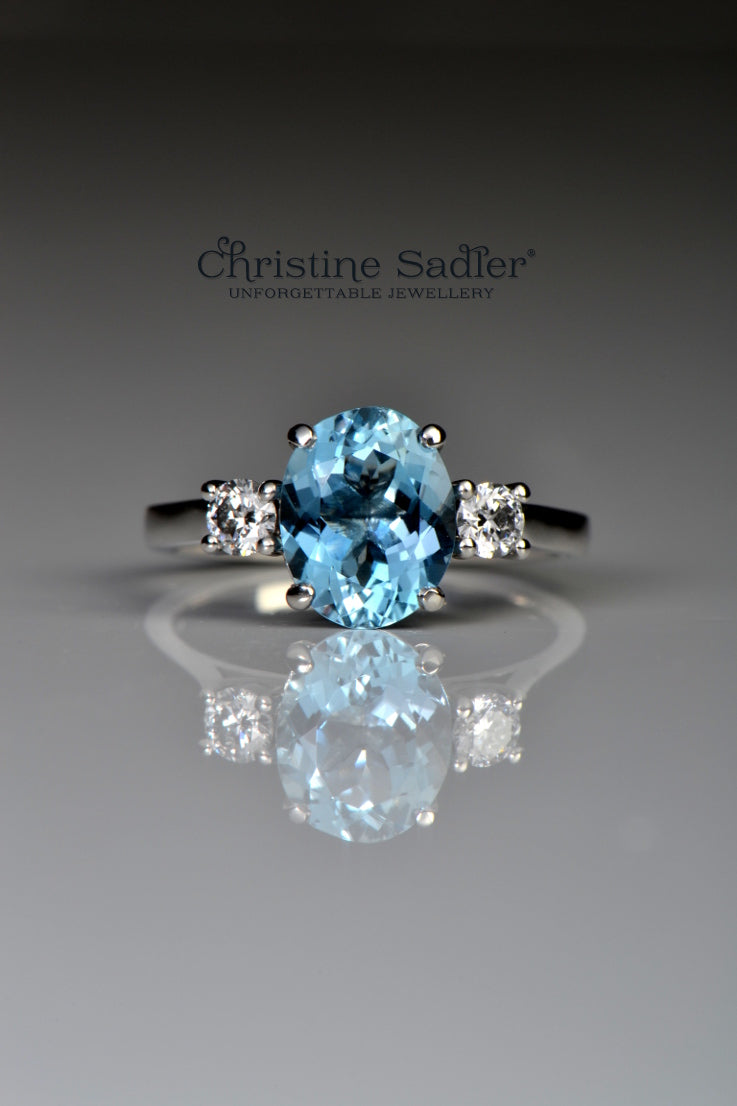 Platinum aquamarine and diamond three stone ring