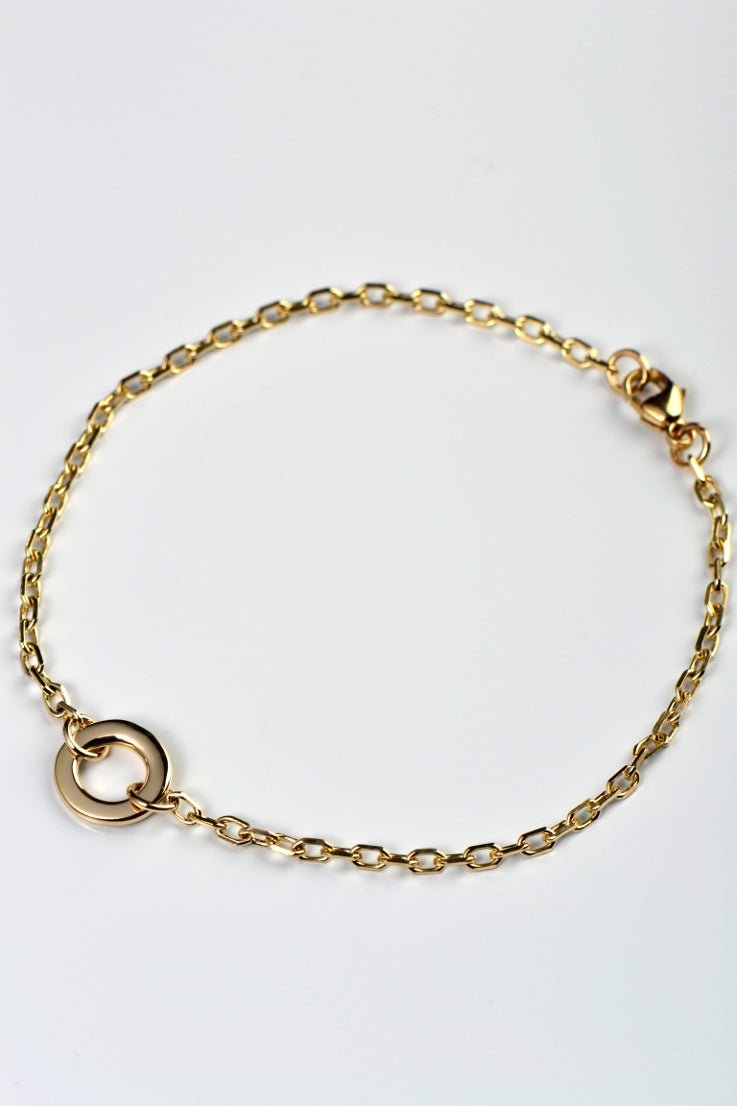 A real gold delicate bracelet with a gold circle at the front in the chain from British jewellery designer Christine Sadler