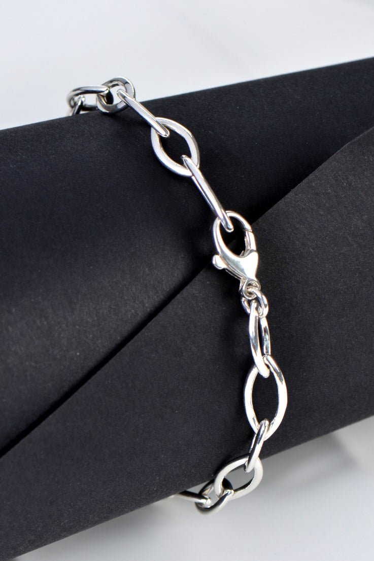 Alternating 15mm and 12mm silver elliptical links on the Life Modern Bracelet.