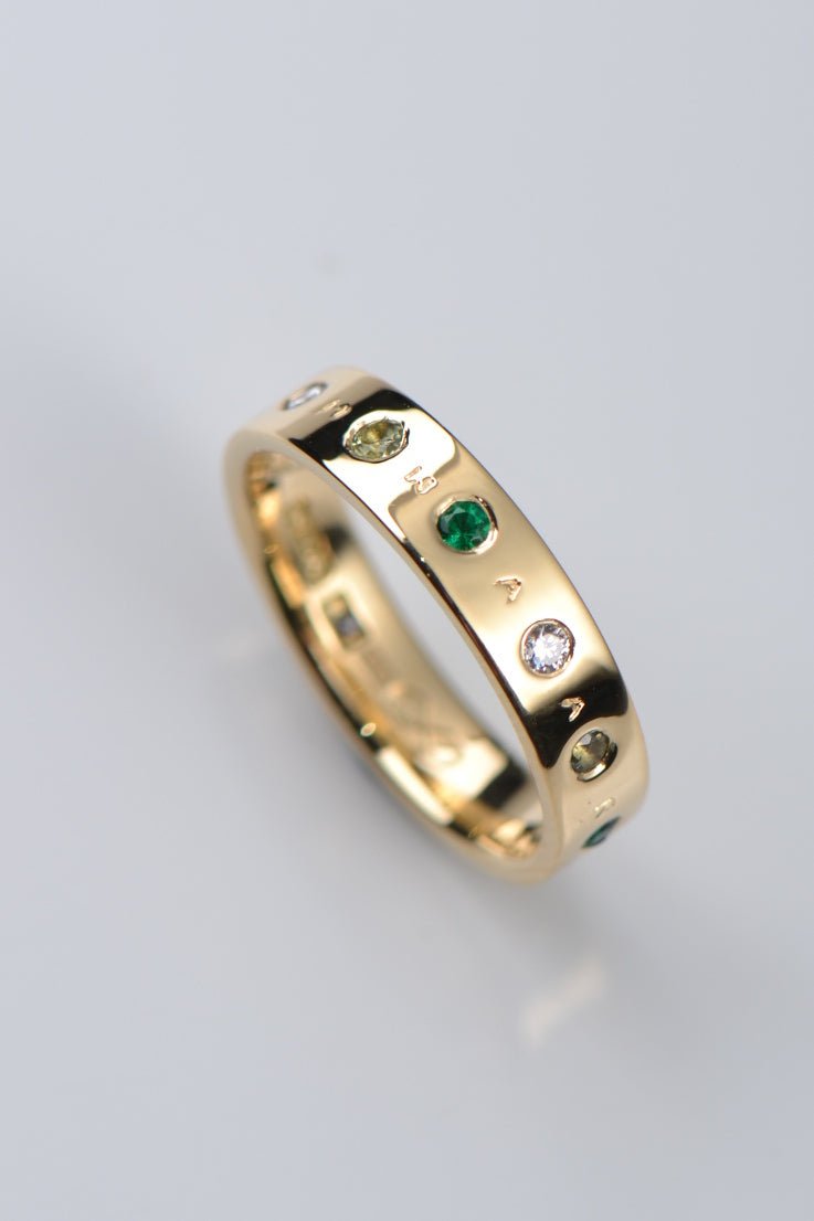 Yellow gold personalised gemstone ring. This design hides a secret code by jewellery designer Christine Sadler who is based in Ayr