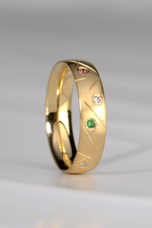 18ct designer gold band set with different coloured gemstones by scottish jewellery designer Christine Sadler