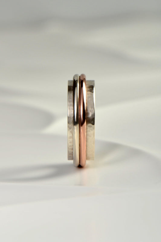 chunky handmade sterling silver hammer textured ring for a man with a rose gold detail from British jewellery designer Christine Sadler