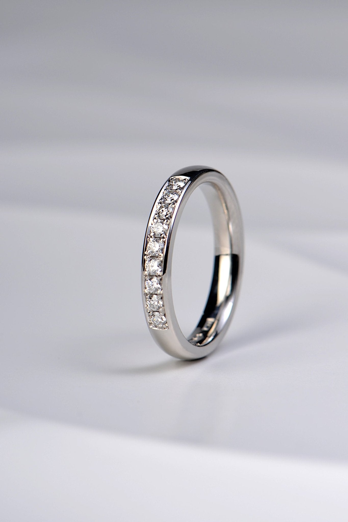 handmade platinum wedding ring pave set with nine diamonds, made in the UK