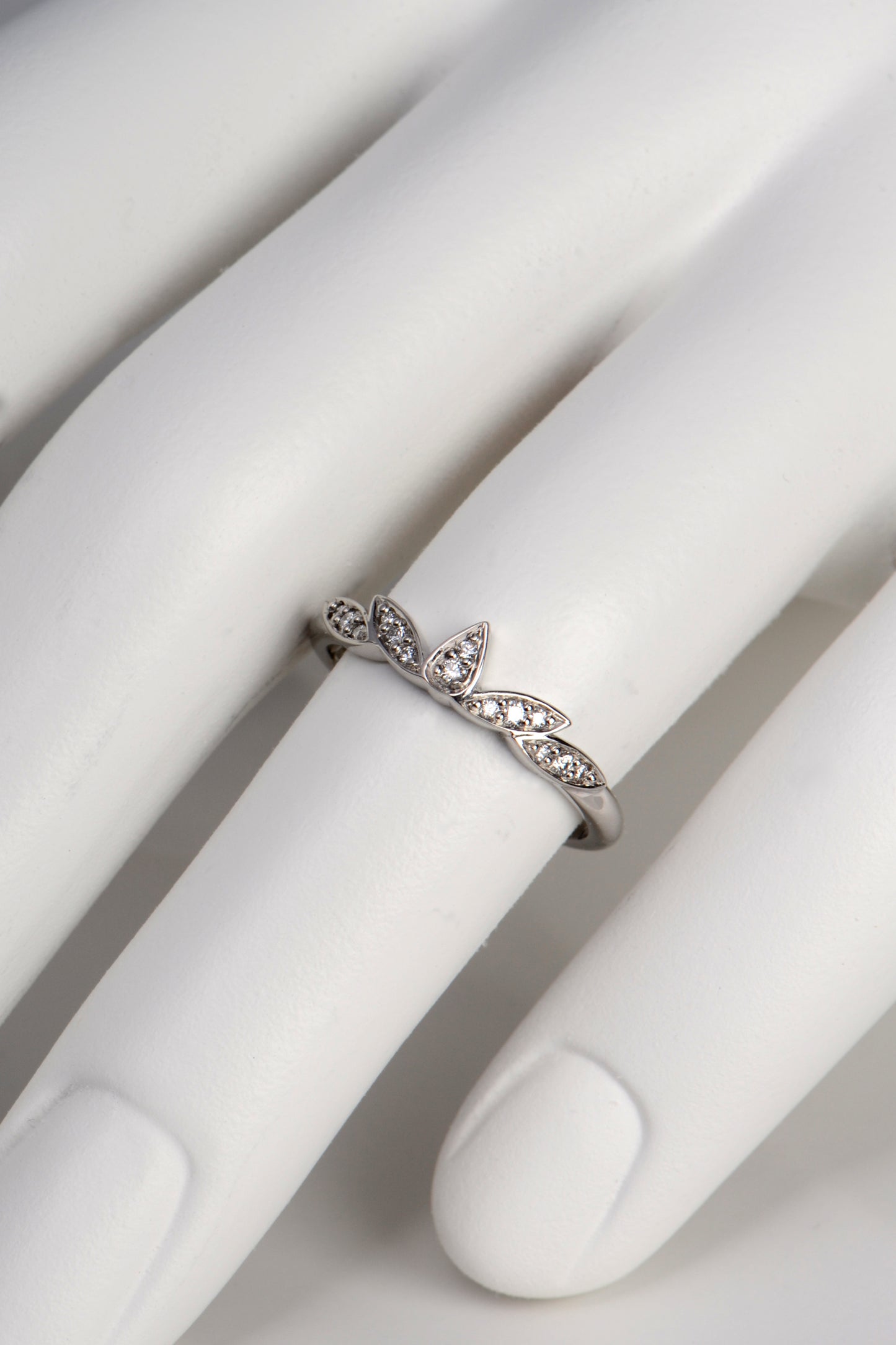 Modern delicate platinum and diamond wedding ring that has petal shaped design, handmade in the UK