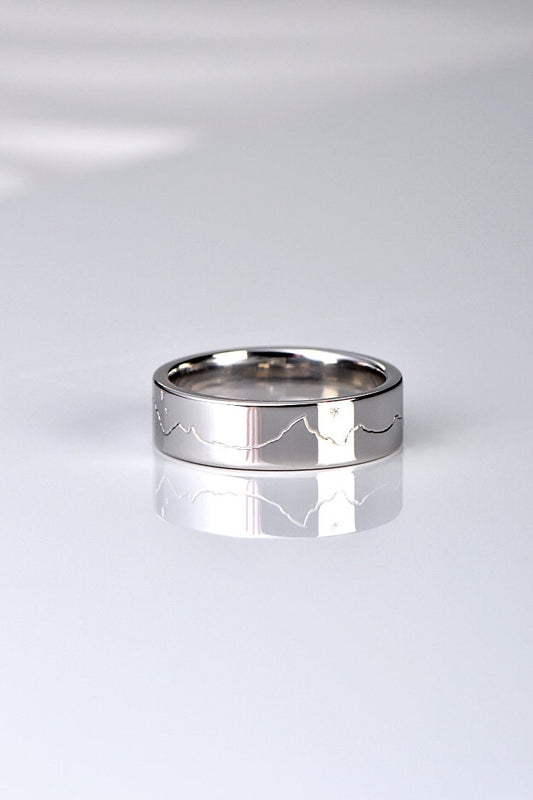different and special wedding ring design hand engraved with a mountain range and a moon and stars
