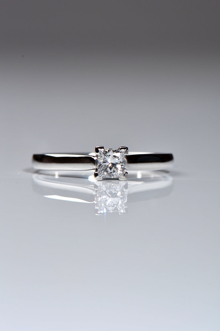 Platinum princess cut diamond ring with blue diamonds