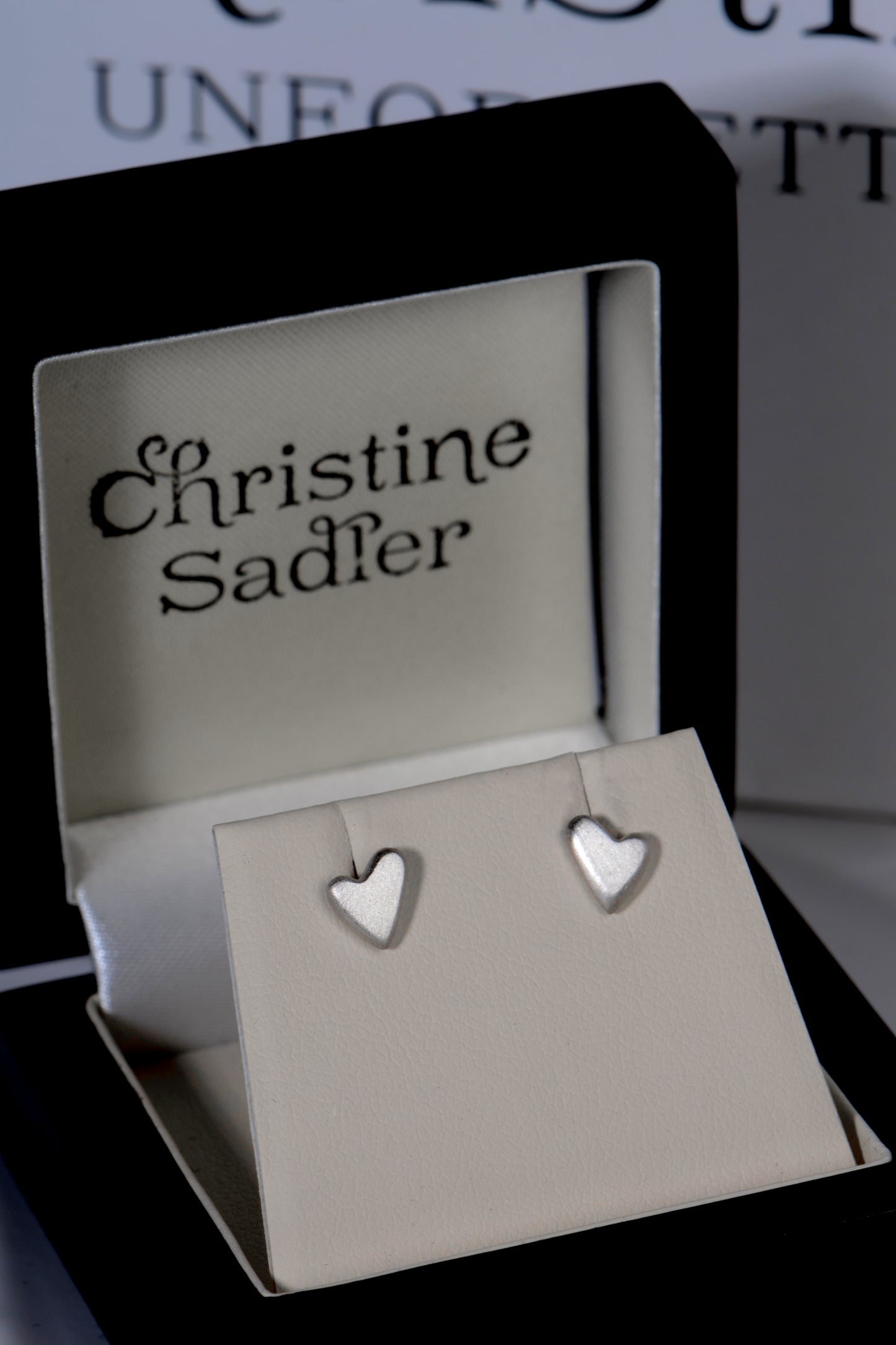 Handmade silver heart earrings displayed in Christine Sadler branded gift box – symbolic jewellery for meaningful gifting