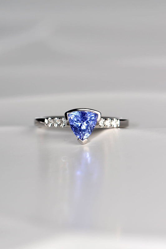 trillion cut tanzanite ring with three diamonds on either side exclusively available from fine jewellery designer Christine Sadler