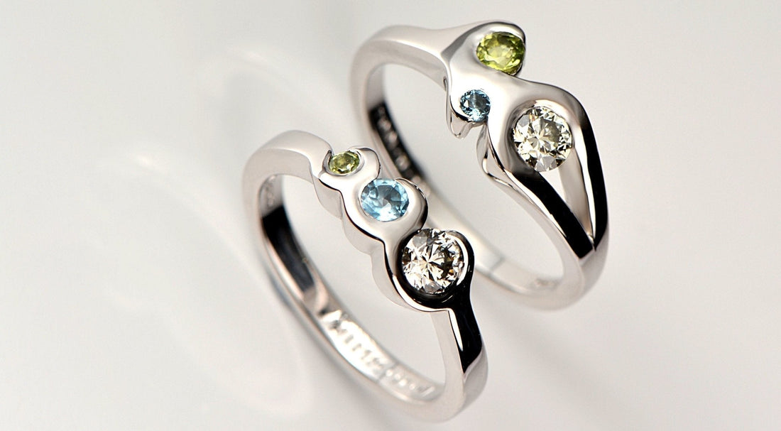 Two engagement rings set with the couple's birthstones - Christine Sadler Unforgettable Jewellery