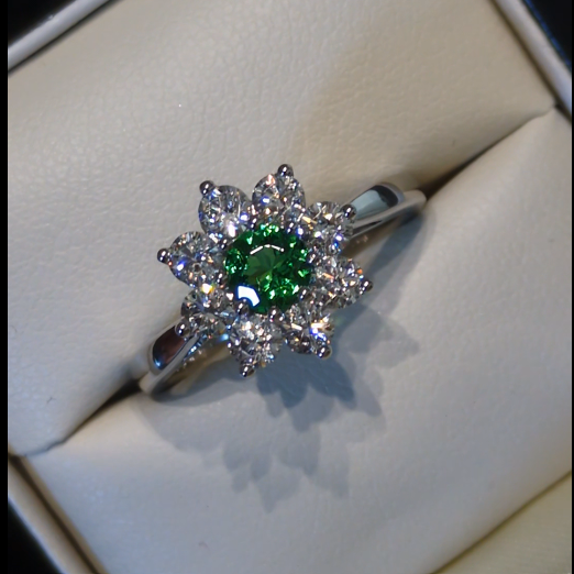 flower cluster platinum ring with a green garnet and natural diamonds