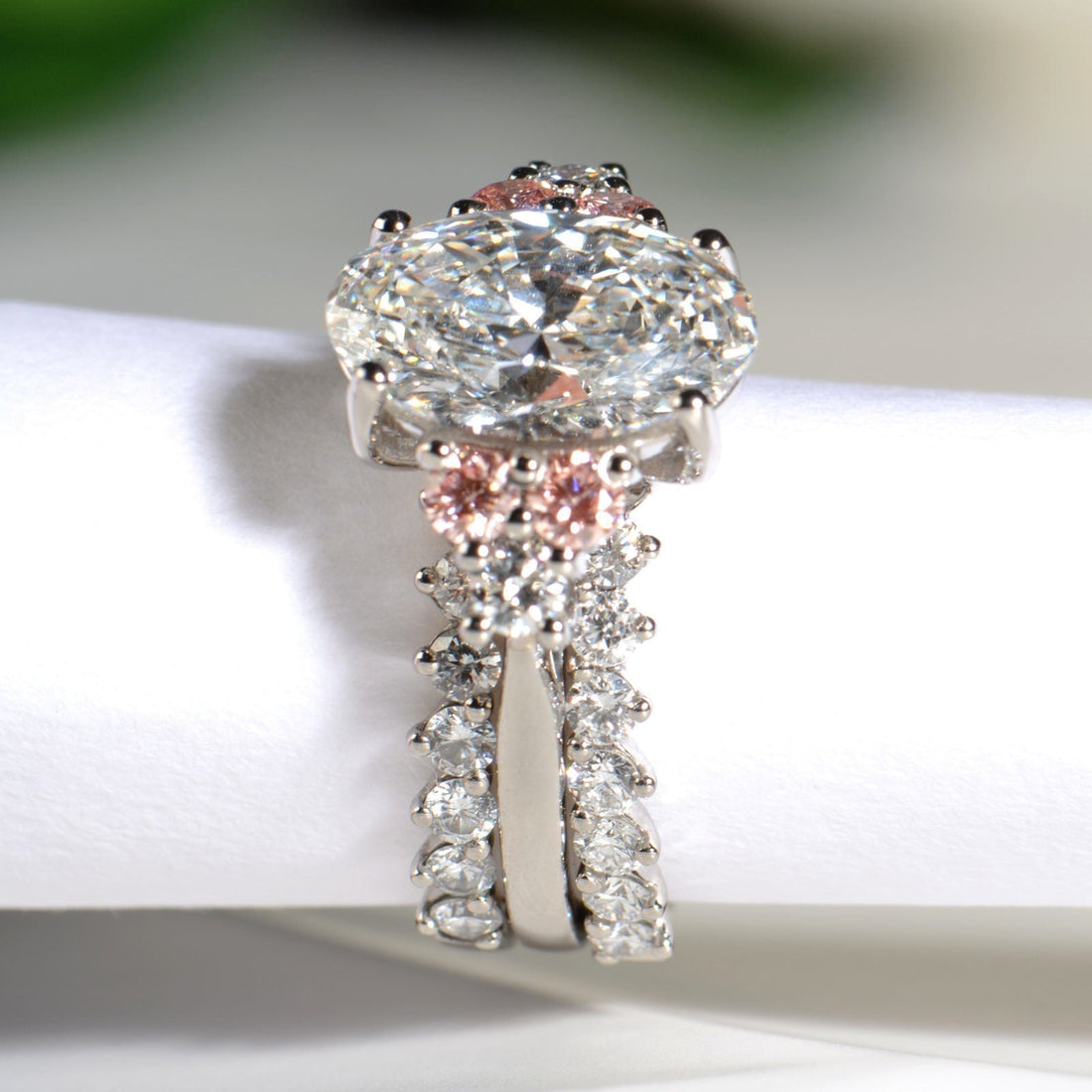 Platinum engagement ring framed by two guard rings on either side, creating a symmetrical bridal set