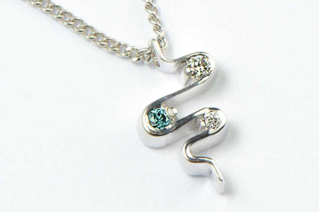 blue and white diamond platinum necklace in the shape of a heartbeat, given as a wedding gift - Christine Sadler