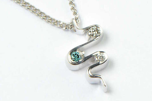 blue and white diamond platinum necklace in the shape of a heartbeat, given as a wedding gift - Christine Sadler