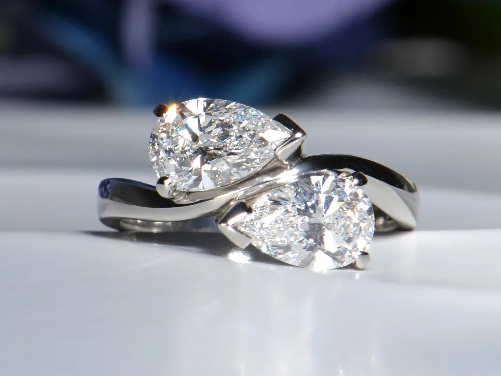 A custom two-carat platinum wave ring featuring two matching pear-cut lab diamonds set in a bespoke Moi et Toi layout. Christine Sadler