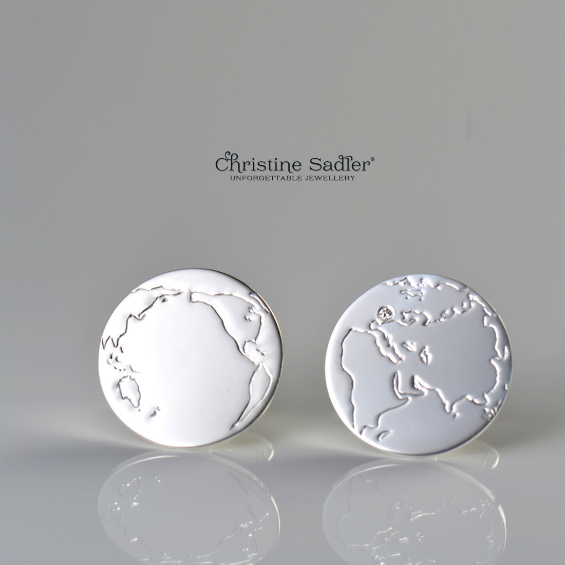 World map cufflinks set with a diamond