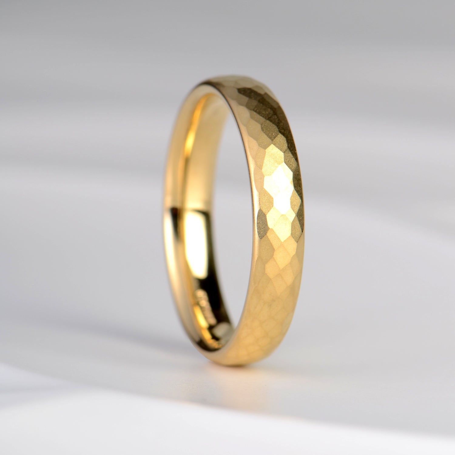 modern hammered textured wedding ring for a man in 18ct yellow gold