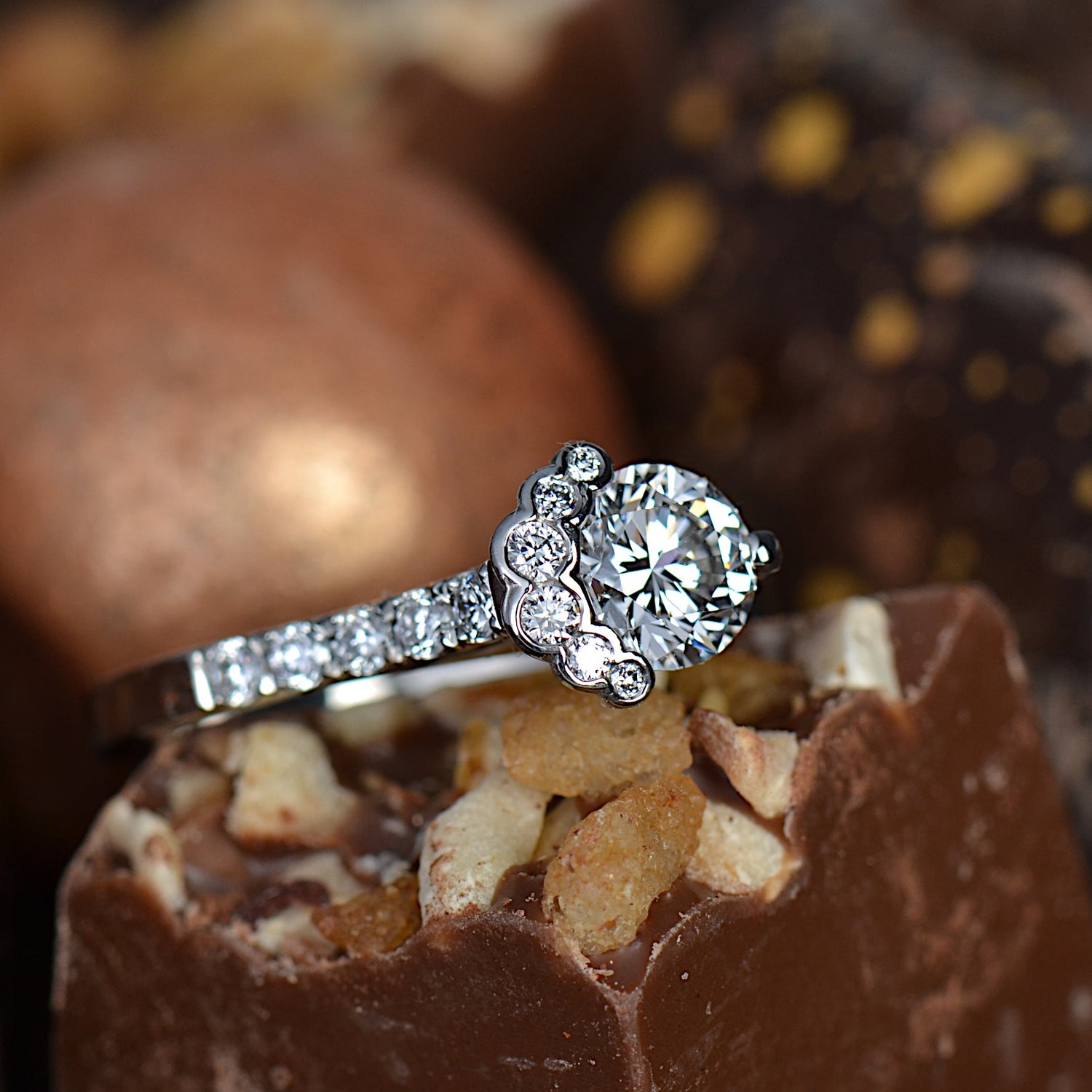 Designer diamond ring by Christine Sadler sitting on luxury chocolates