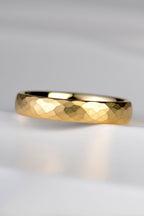 an 18 carat yellow gold wedding ring that is modern and different with a hammered texture and brushed finish