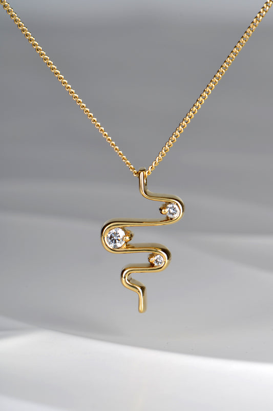close up of 18ct yellow gold heartbeat three stone diamond designer pendant on 45cm chain