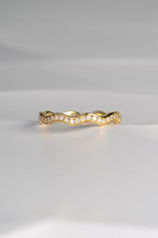 narrow 18ct gold diamond set wavy ring that can be stacked with other rings