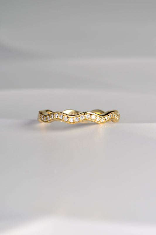 narrow 18ct gold diamond set wavy ring that can be stacked with other rings