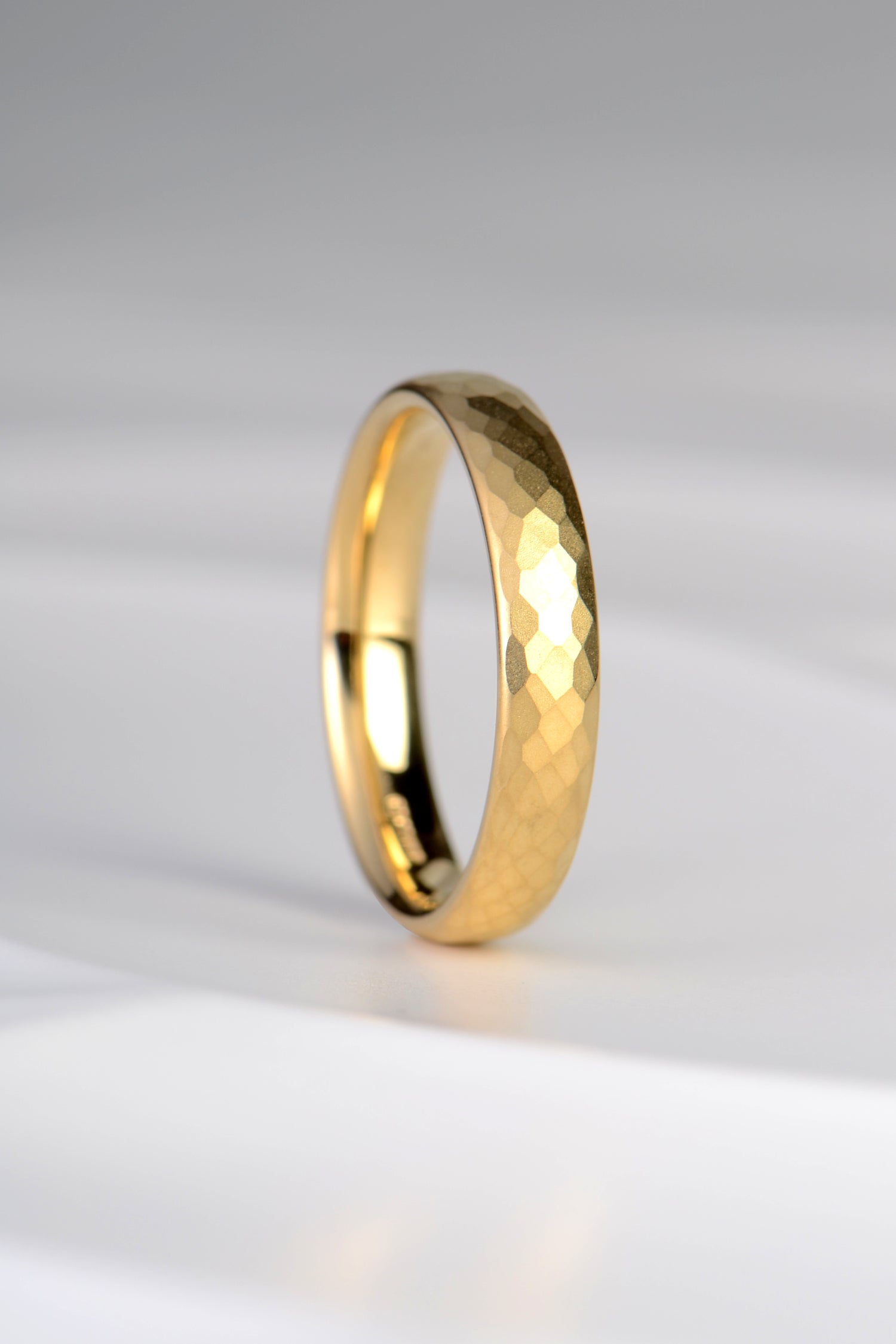modern 18ct yellow gold wedding ring for a man or for a woman with a textured finish that makes it really special and different