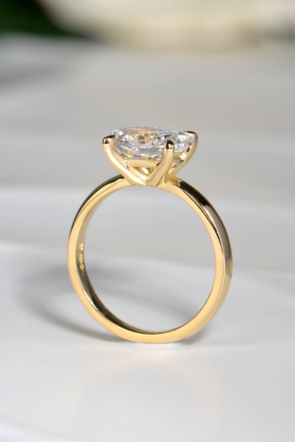 View through the 18ct yellow gold ring set with 2ct oval lab grown diamond showing the elegant four claw setting.