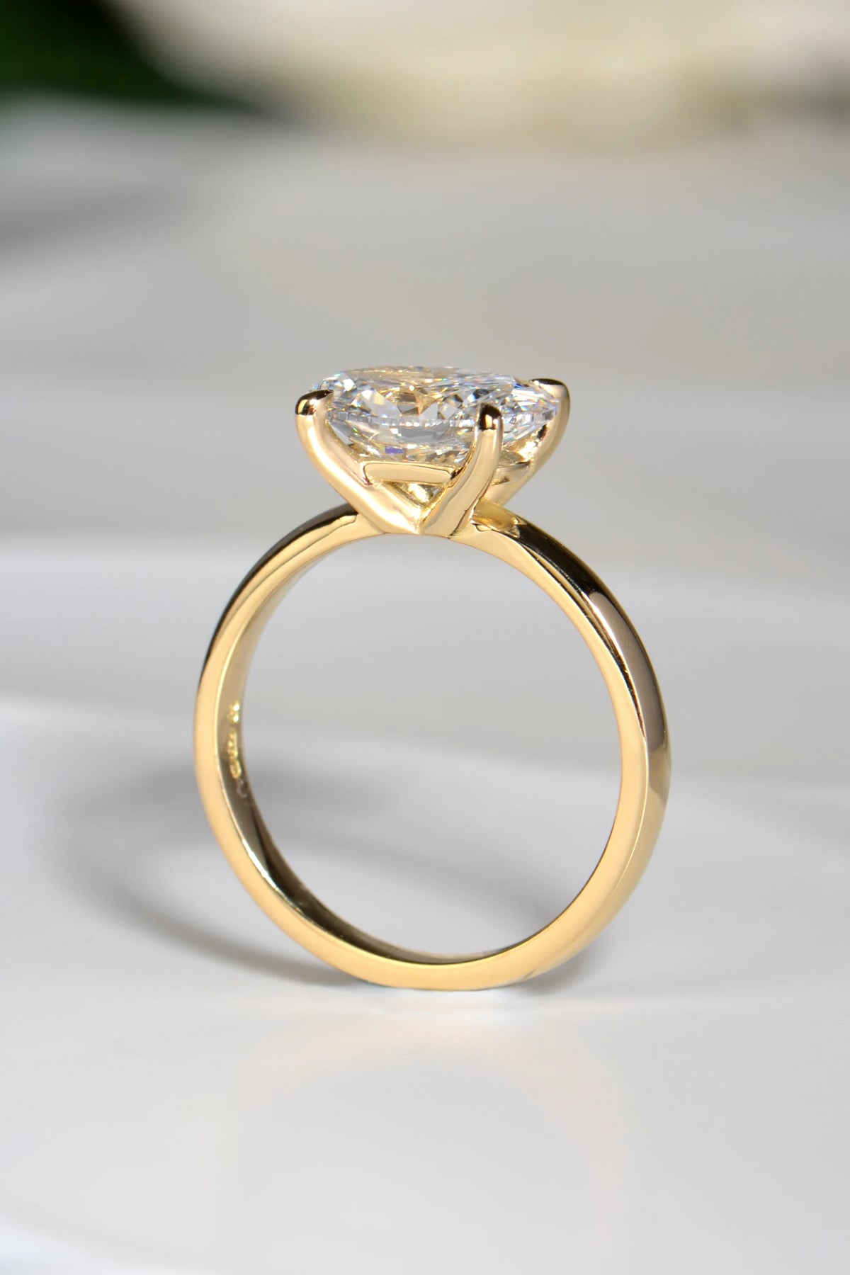 View through the 18ct yellow gold ring set with 2ct oval lab grown diamond showing the elegant four claw setting.