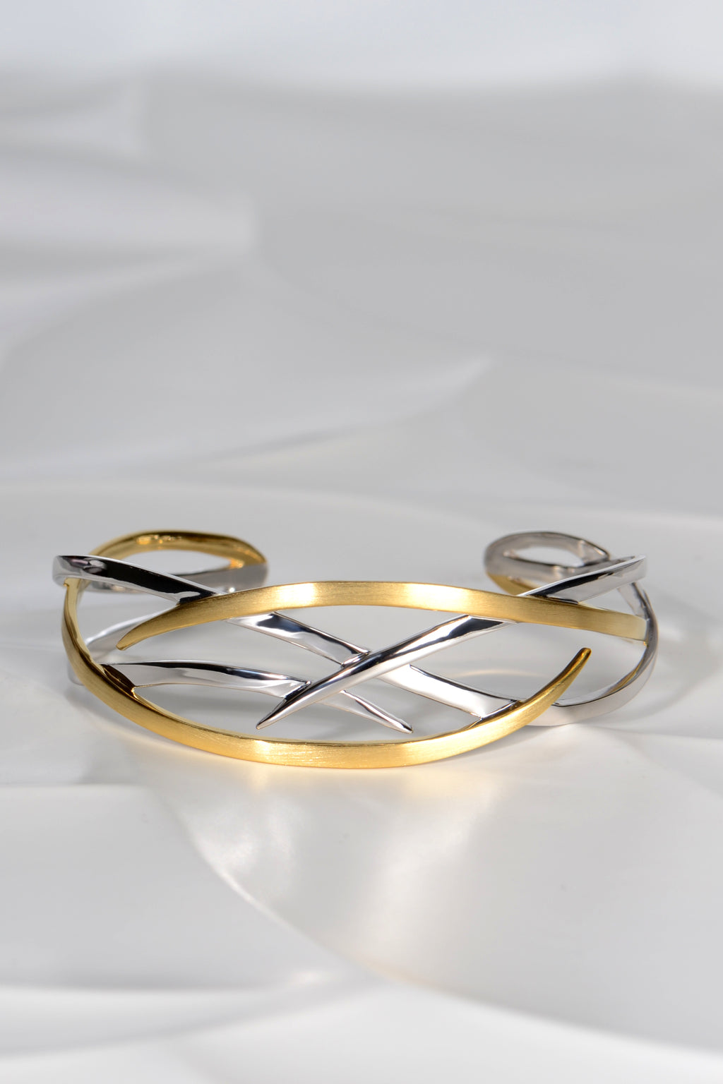 criss cross silver and 18ct gold plated details on the Jorge Revilla roots bangle