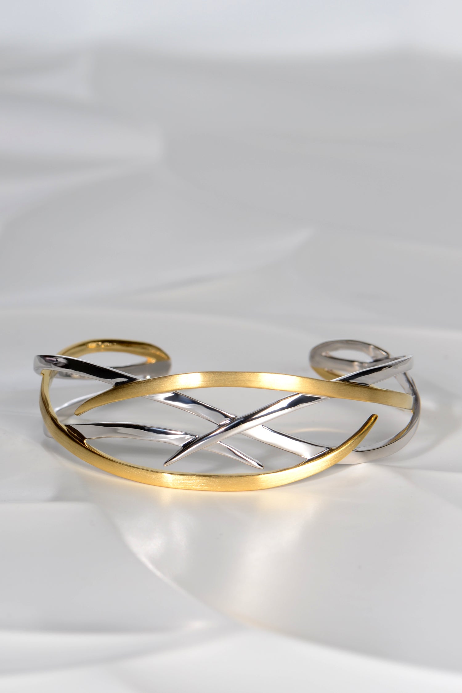 criss cross silver and 18ct gold plated details on the Jorge Revilla roots bangle