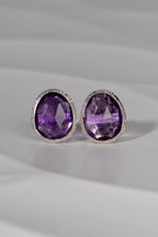 Pair of silver and amethyst birthstone earrings with polished silver backs